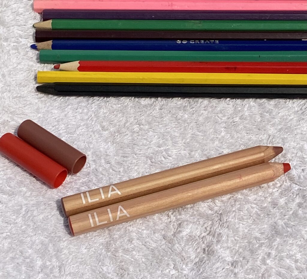 Ilia Lip Sketch Hydrating Crayons image, lids off showing shades with pencils behind