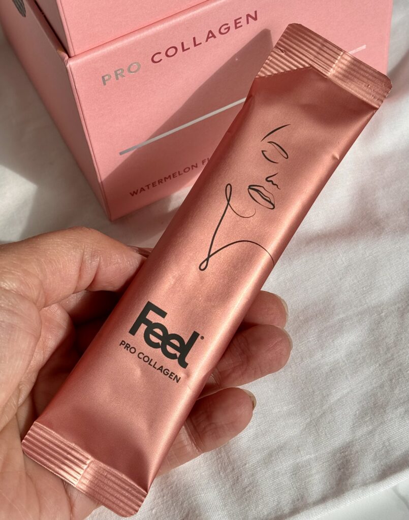 Holding the Feel Pro Collagen Watermelon Powder sachet in hand