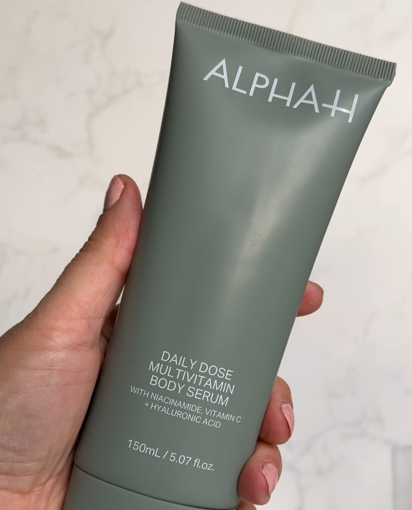 Alpha_H Daily Dose Multivitamin Body Serum bottle held in hand