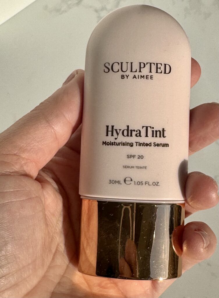 Sculpted by Aimee HydraTint bottle in hand