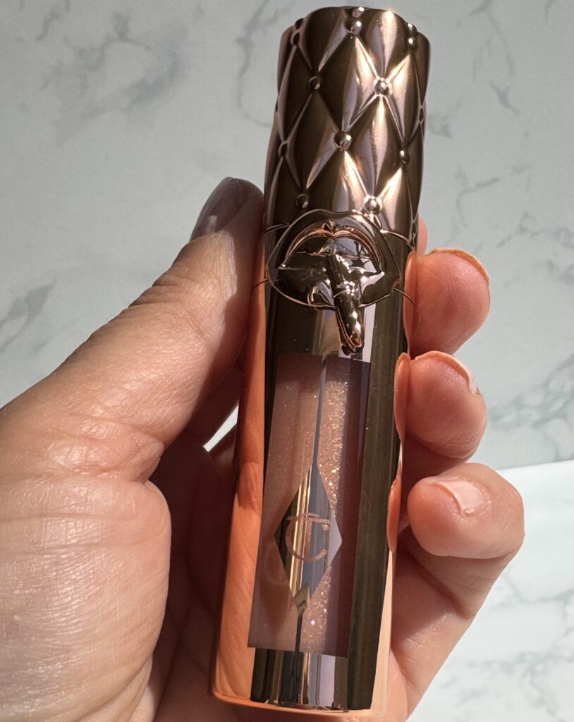 Holding the Charlotte Tilbury Big Lip Plumpgasm in Nudegasm Diamonds
