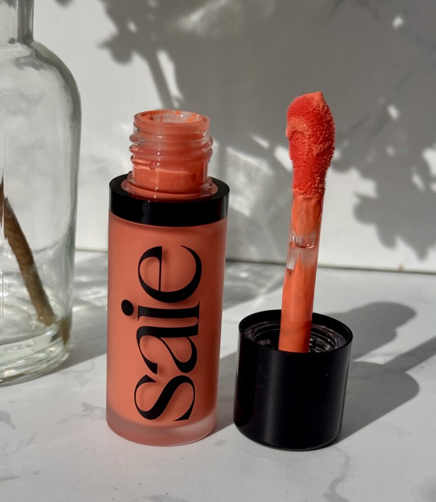 Open tube of Saie Dew Blush showcasing Doe Foot applicator