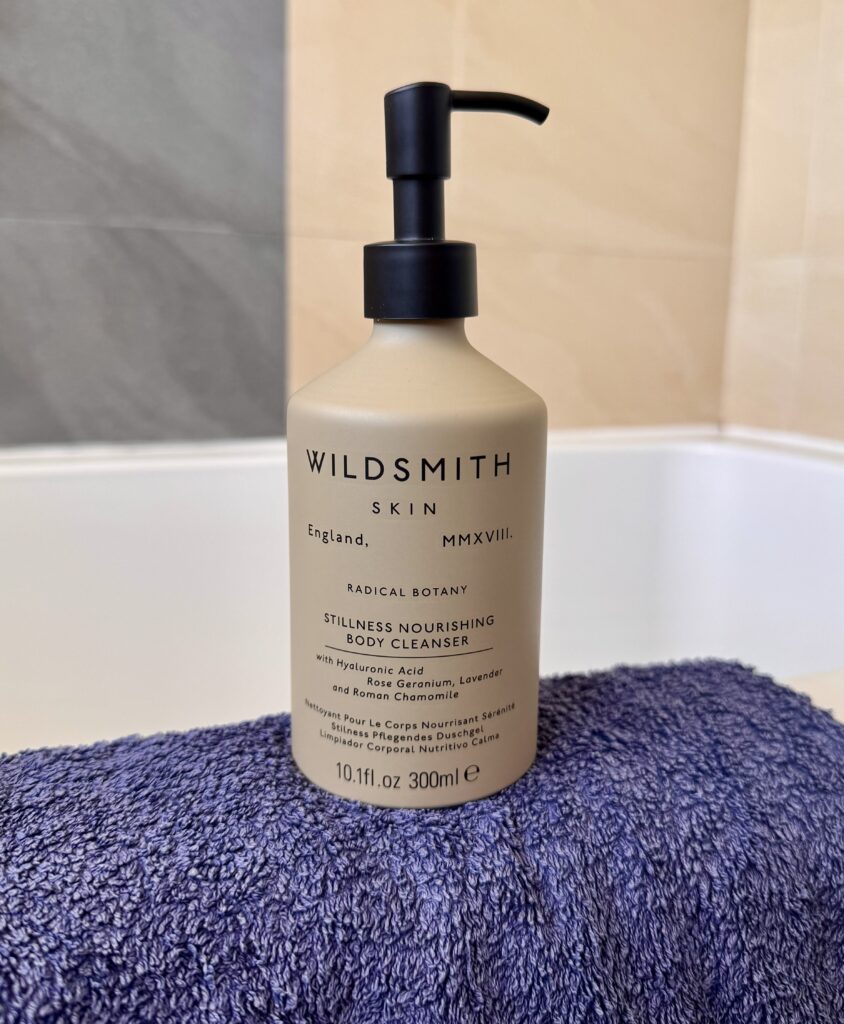 Wildsmith Skin Stillness Nourishing Body Cleanser on towel in bathroom