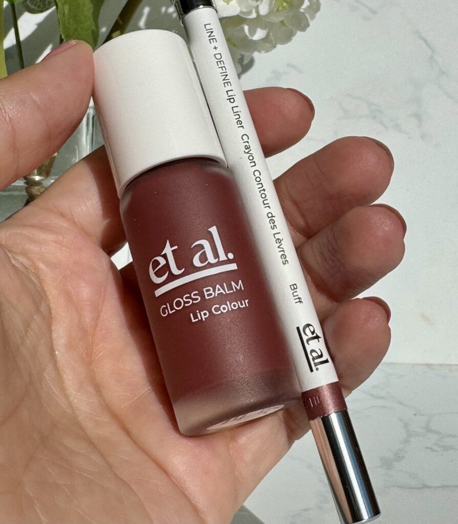Holding Et Al Gloss Balm Lip Colour and Line + Define Lip Liner in hand
