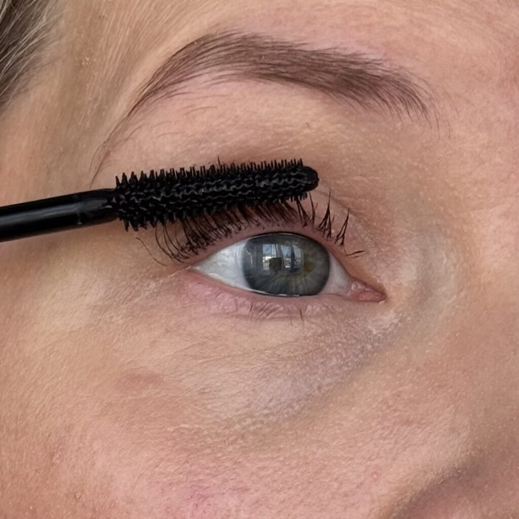 Applying RUM Wrap Party mascara, close up of application and wand