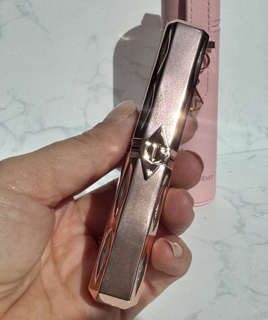 Charlotte Tilbury Pillow Talk Blush Balm held in hand to showcase the rose gold packaging