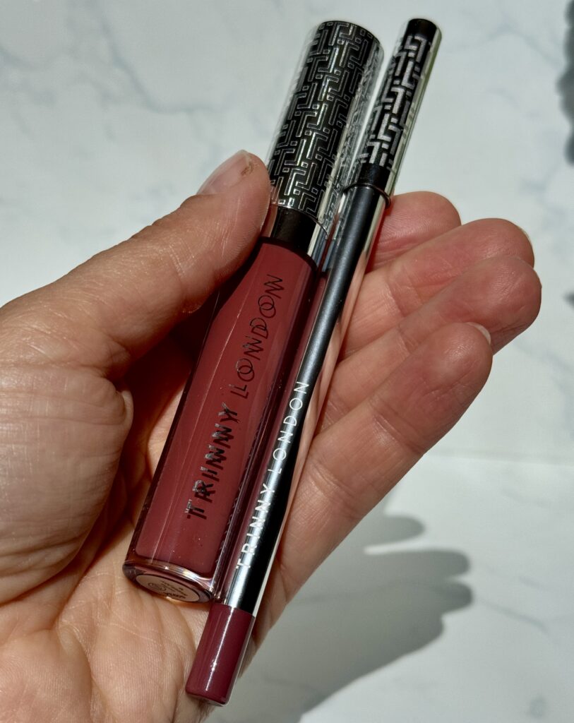 Holding in hand Trinny London Lip Reset in shades Sofia and Anya