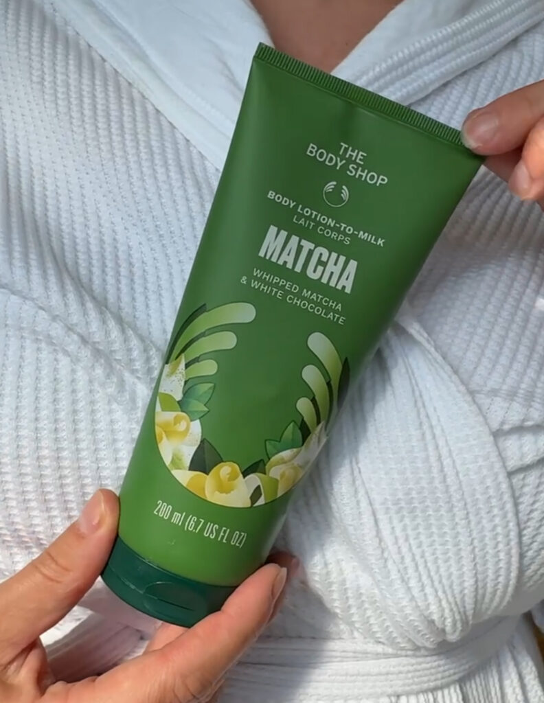 Holding Body Shop Whipped Matcha and White Chocolate Body Lotion to Milk in hands